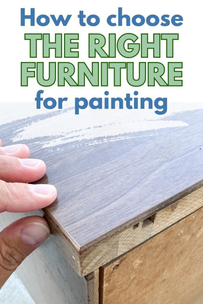 A hand touching the top of a wooden dresser