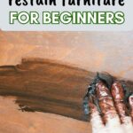 Gloved hand applying dark wood stain to furniture, with text: How to restain furniture for beginners.