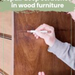 Hands using blending sticks to repair scratches on a wooden dresser