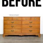 A wooden dresser with brass handles