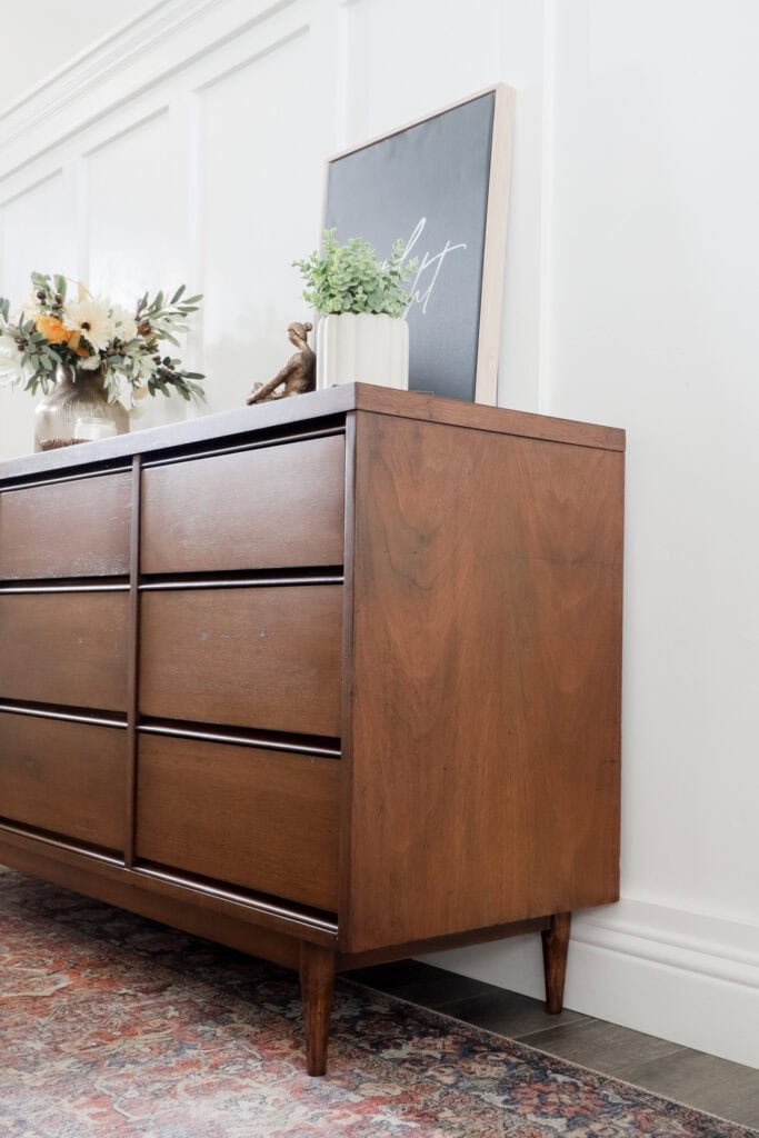 Refinished mcm dresser with plant decor on it