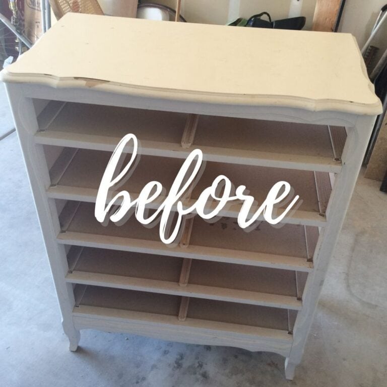 White dresser without drawers in a garage, with before written across the front.