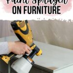 A person uses a paint sprayer on a light-colored piece of furniture. Text reads How to use a paint sprayer on furniture.