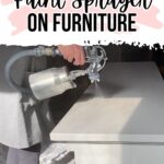 Person using a paint sprayer to paint a piece of white furniture, with text above reading the tutorial topic.