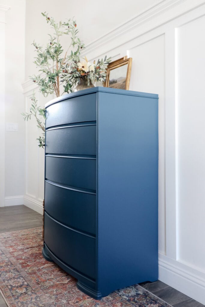 Side view of blue dresser with five drawers