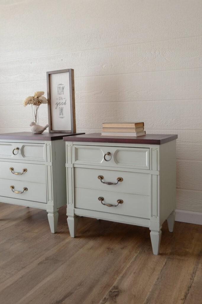 Two light green nightstands with dark stained tops