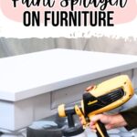 Hand holding a paint sprayer, painting a white table; text reads: How to use a paint sprayer on furniture.
