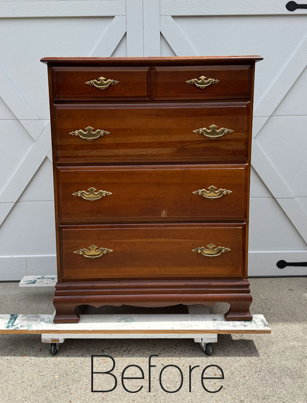 A vintage wooden dresser with brass handles
