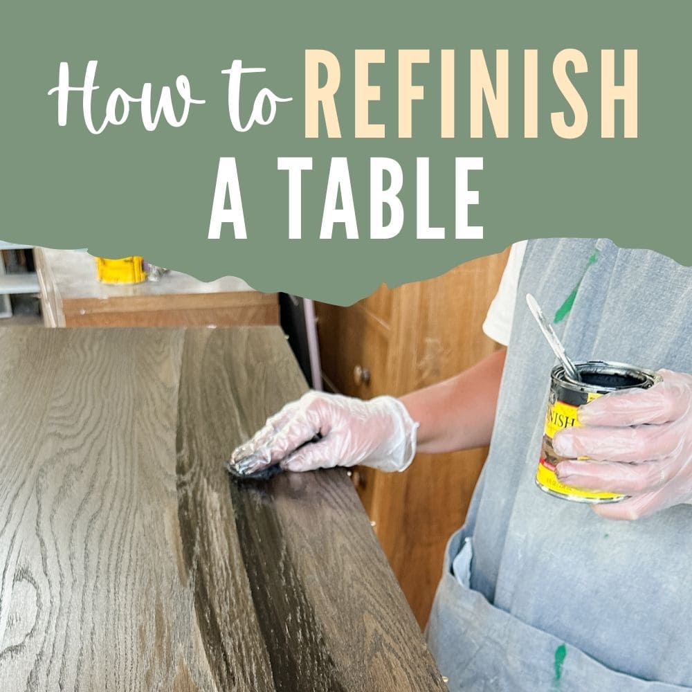 Person refinishing a wooden table with stain