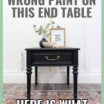 A black end table with decor on top, against a white wall. Text says, “I used the wrong paint on this end table. Here is what worked instead!”.