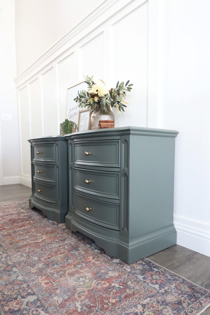 Side view of two green dressers with gold knobs