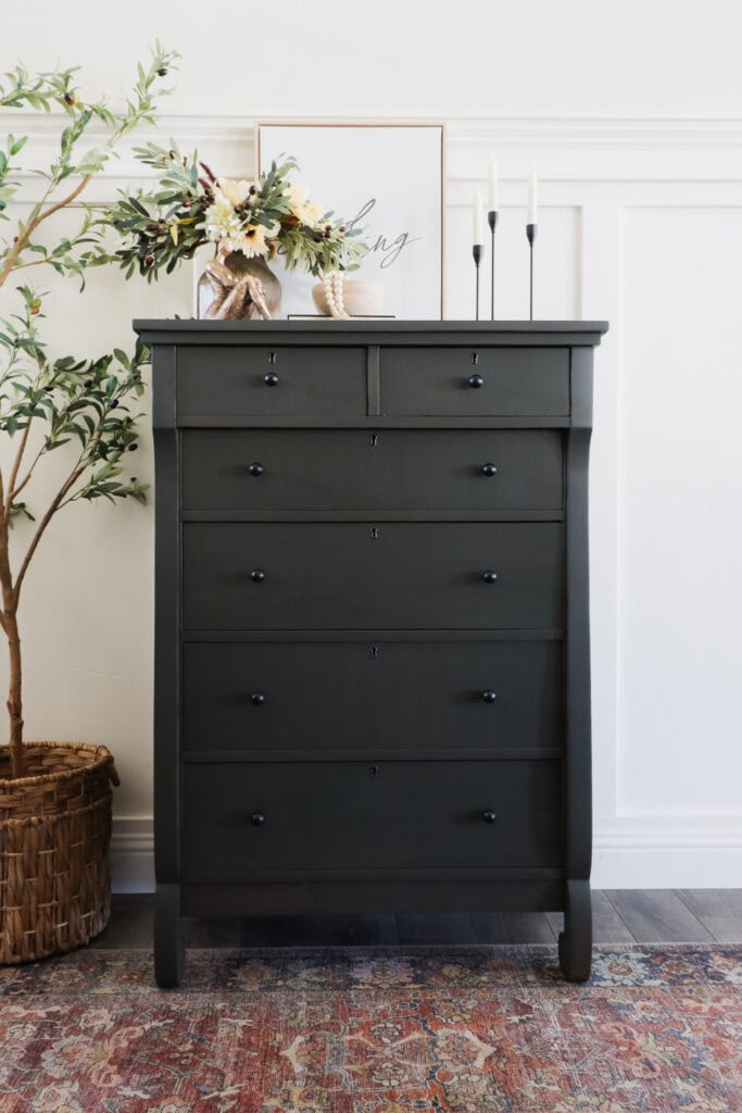 dresser after wood stain makeover with decor and plant