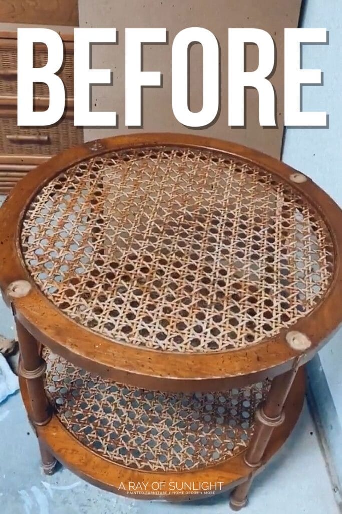 A worn round wooden side table with a cane top and BEFORE written in large white letters above it.