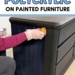 Person applying polycrylic to a painted dresser with a sponge, wearing gloves.