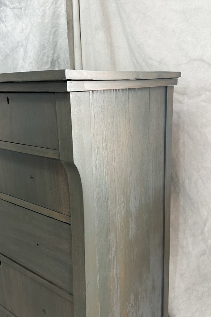 closeup of side of dresser with uneven paint wash