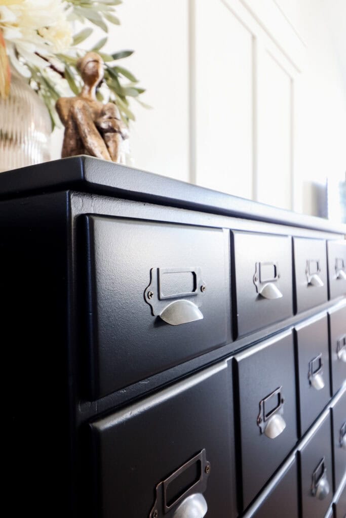 closeup of card catalog pulls on black nightstand