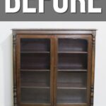 An empty vintage wooden cabinet with glass doors, labeled BEFORE above in bold white letters.