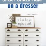 White dresser with dark handles with text about spray chalk painting dresser.