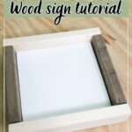 Square wood sign frame with Easy DIY Wood sign tutorial text over it, on a light wood table.