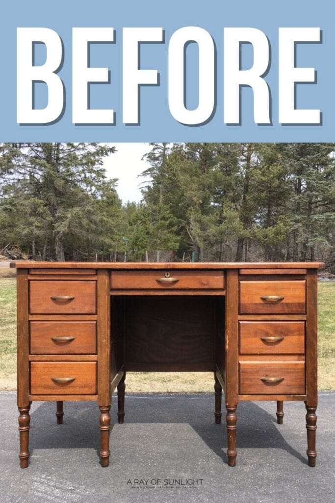 Wooden desk with 7 drawers sits outside on pavement, surrounded by trees. BEFORE is written above.