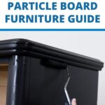 Hand painting black paint on particle board furniture with a paint roller, text reads Particle Board Furniture Guide