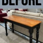 A wooden table with black legs stands in front of a beige couch in a living room. BEFORE is written above.