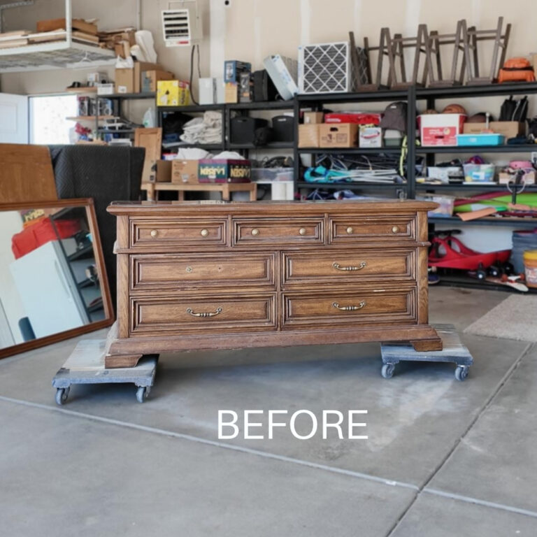A wooden dresser sitting on two furniture dollies in a garage, labeled BEFORE.
